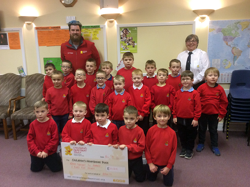 Anchor Boys in Northern Ireland present £11,000 cheque to Children's Heartbeat Trust.